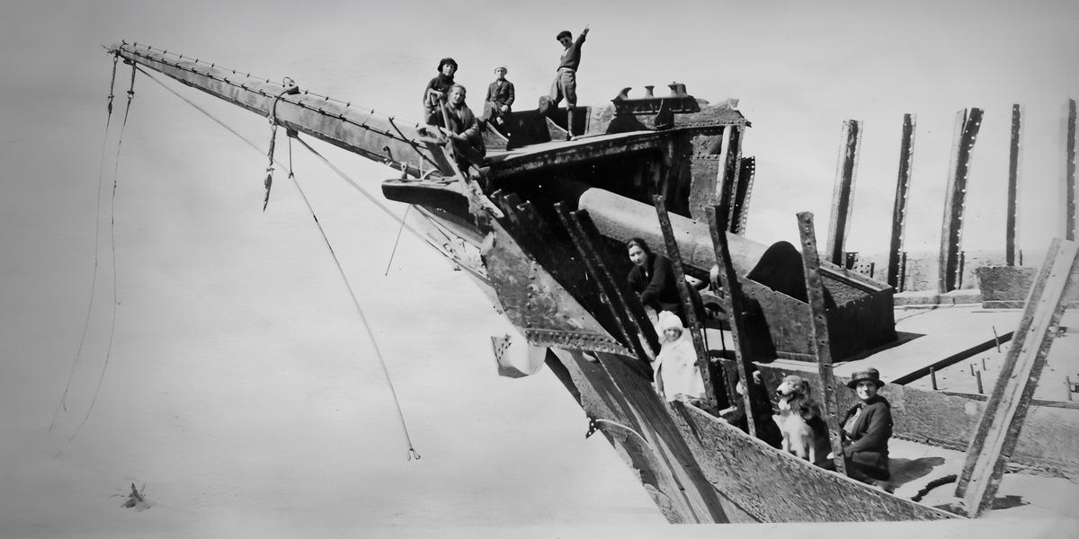 Archival photograph of workers on a jetty construction trestle.